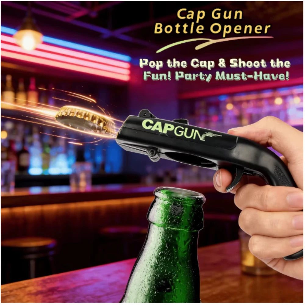 A hand holds a black cap gun bottle opener, firing a golden spark from a green glass bottle in a bar setting.