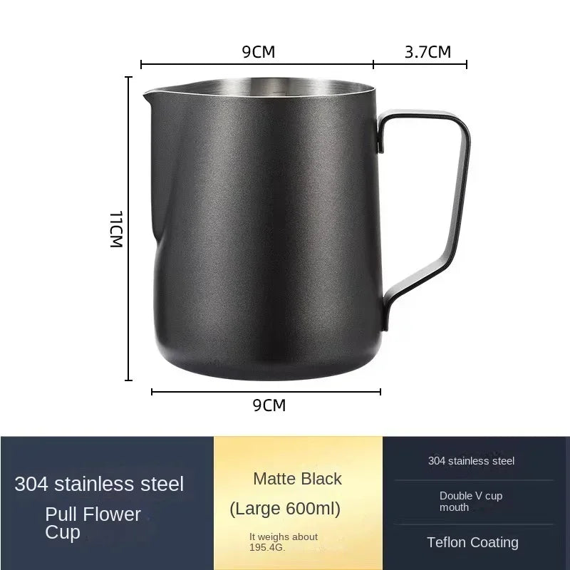 Matte black stainless steel coffee frothing pitcher with a handle and measuring lines.