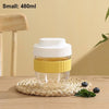A small yellow food container with a white lid sits on a woven mat on a wooden surface.