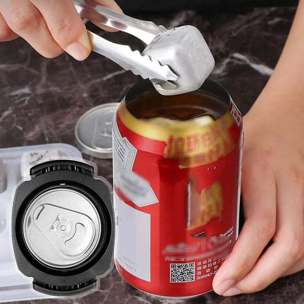 A hand uses a metal tool to open a can of soda, next to a plastic opener device.
