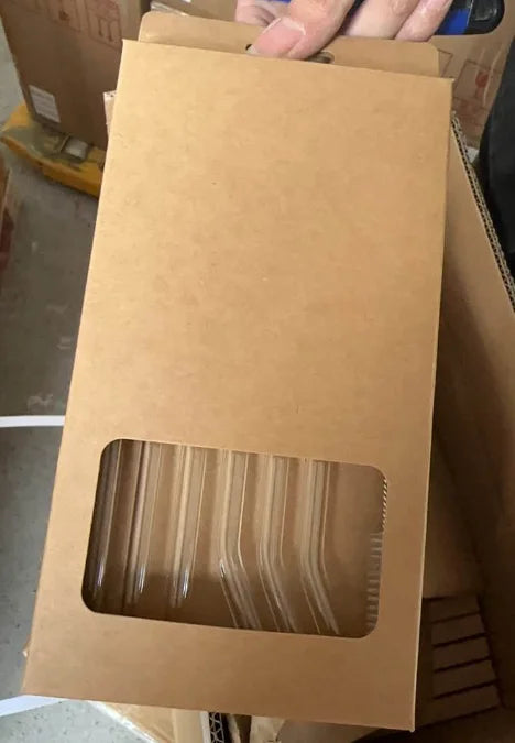 A package of reusable glass smoothie straws with a cleaning brush is shown in a cardboard box.