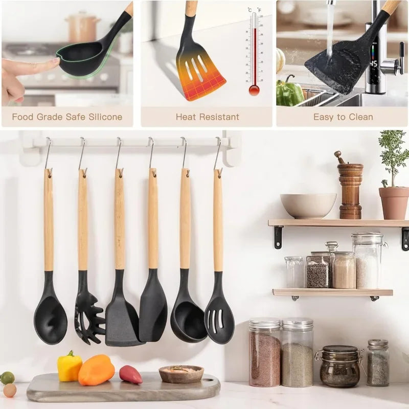 A set of black silicone kitchen tools including spatulas and a knife displayed on a wooden cutting board.