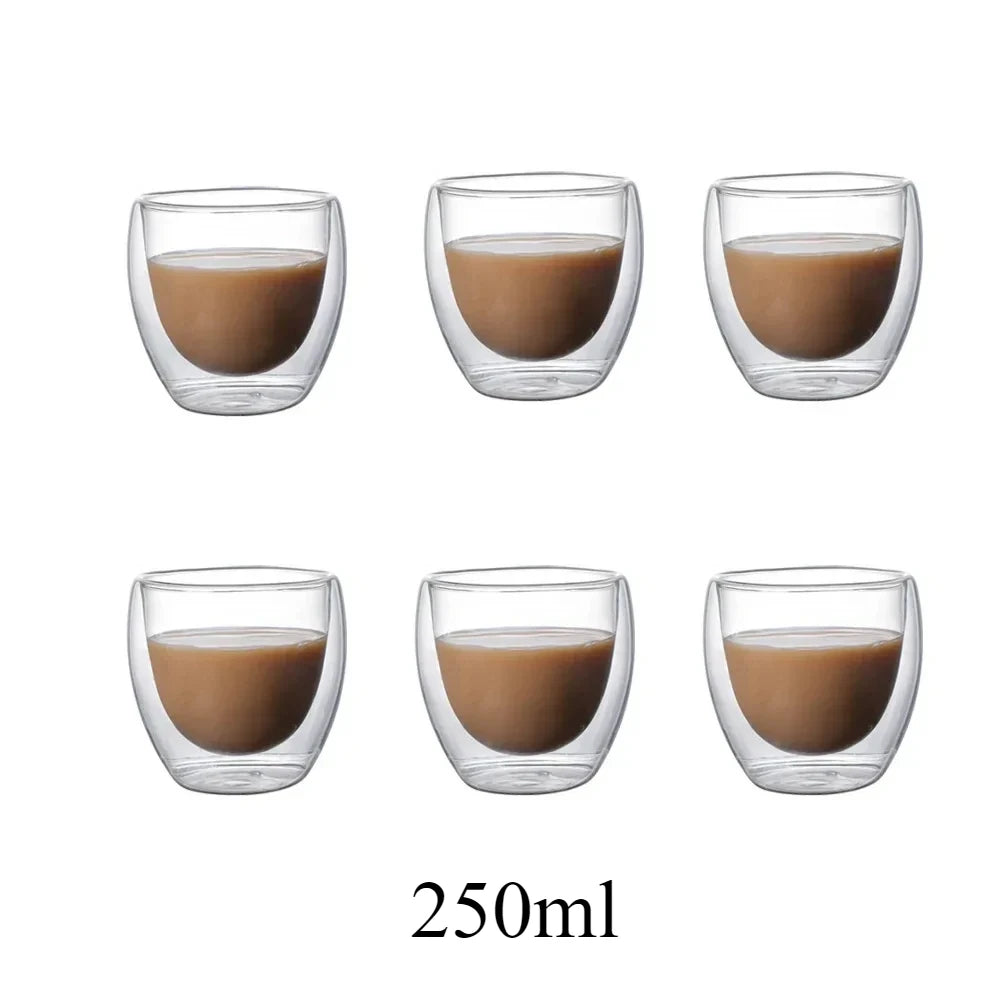 A set of six clear glass coasters filled with a brown liquid or oil.