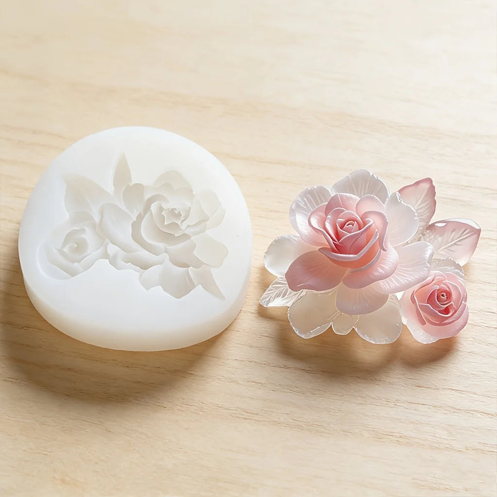A silicone mold shaped like a pink rose flower is shown on a light wooden surface.