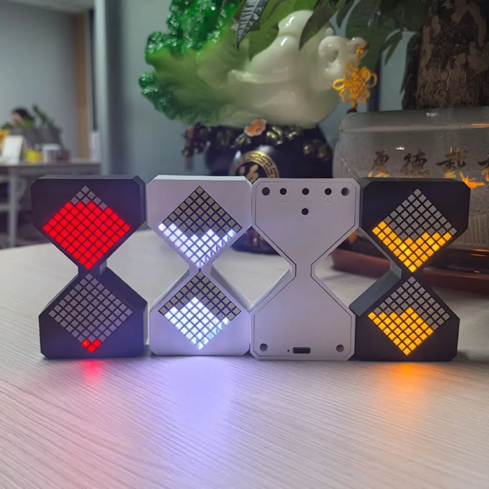A set of four black and white LED digital hourglass timers displayed on a light surface.