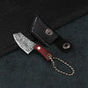 A set of pocket mini knives featuring a Damascus pattern blade, mounted in a black leather sheath with a wooden handle and ch