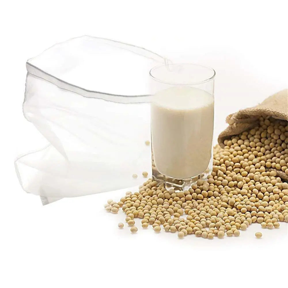 A clear reusable fine mesh food strainer colander filled with light-colored seeds and a glass containing liquid.
