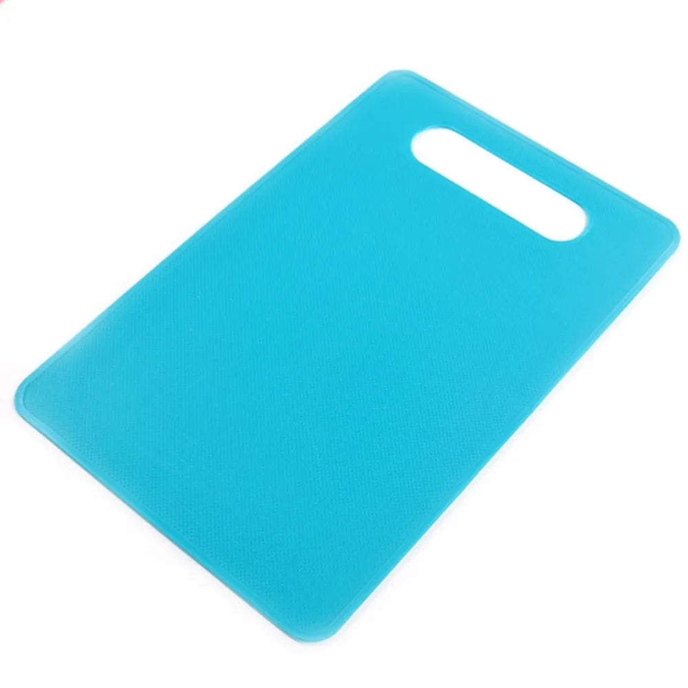 A bright blue plastic cutting board with a handle, shown from above.