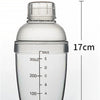 A clear plastic cocktail shaker bottle with volume markings and a screw cap.