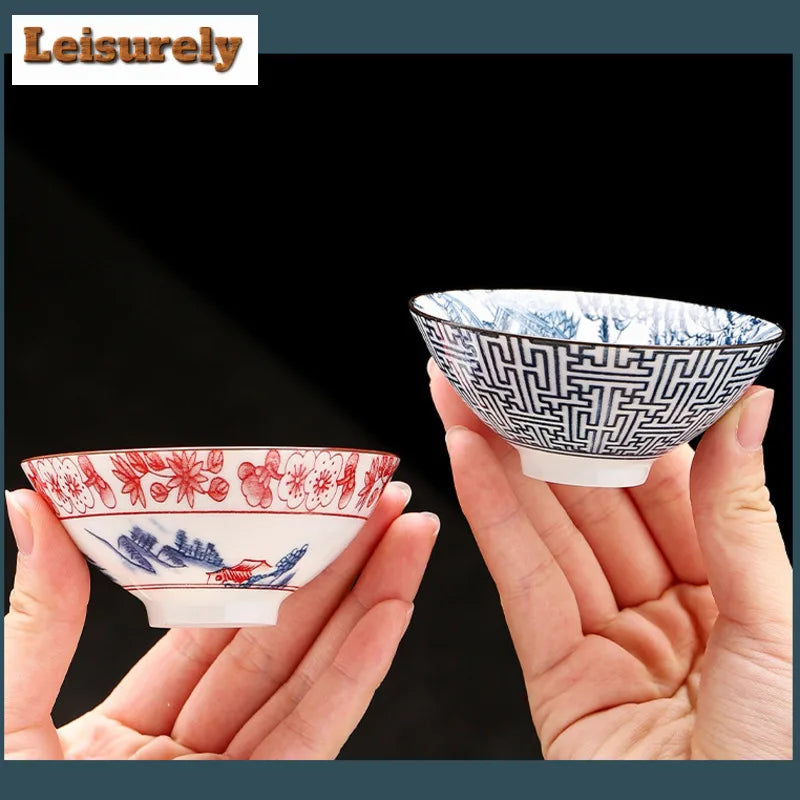 A hand holds a blue and white porcelain bowl with intricate geometric patterns.
