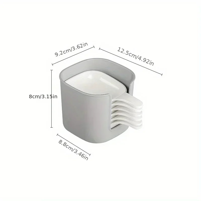 A white plastic sauce dish set with a lid and a pouring spout, shown from the side.