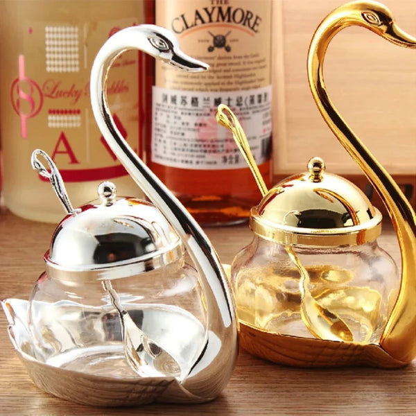 A set of elegant dual-material condiment storage jars featuring silver and gold finishes.