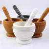 A set of wooden and stone mortars and pestles for grinding ingredients.