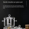 A Nordic double ear glass pot is shown with a base, featuring clear glass pots for cooking and storage.