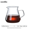 A clear glass coffee server with a handle containing dark brewed coffee.