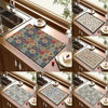 A collection of retro bohemian absorbent dish drying mats with non-slip rubber bases displayed in a wooden cabinet.