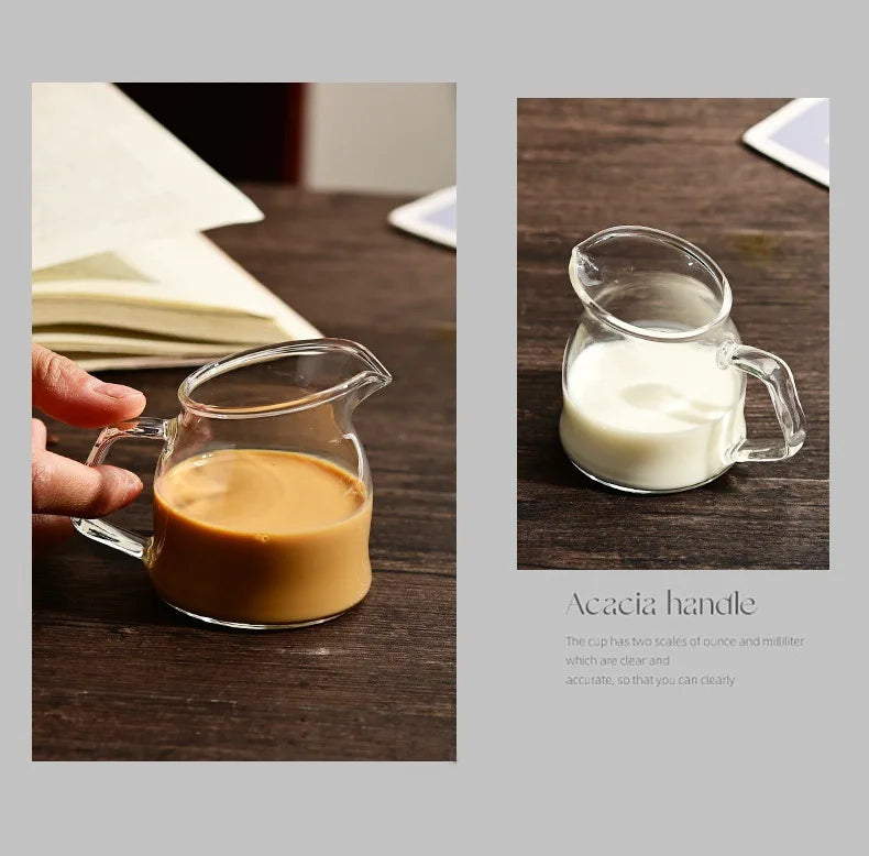 A clear glass serving cup with an acacia handle holds a light brown liquid, next to a glass of white milk.