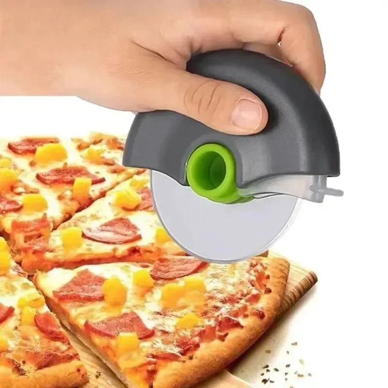 A hand is holding a gray pizza dough slicing tool with a green blade, positioned above a pizza.
