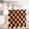 A wooden magnetic knife holder with a checkered pattern displayed on a rustic wooden surface.
