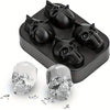Black silicone ice cube molds shaped like skulls and a clear skull mold on a white surface