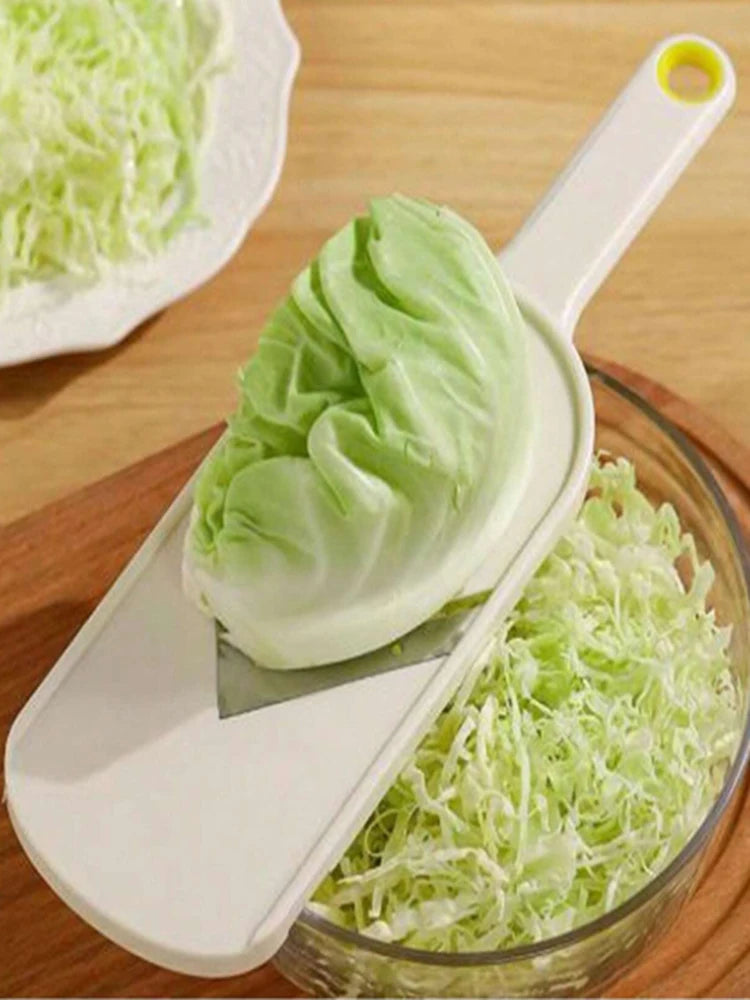 A multi-function vegetable slicer and grater is shown with a piece of sliced celery and grated celery in a glass bowl.