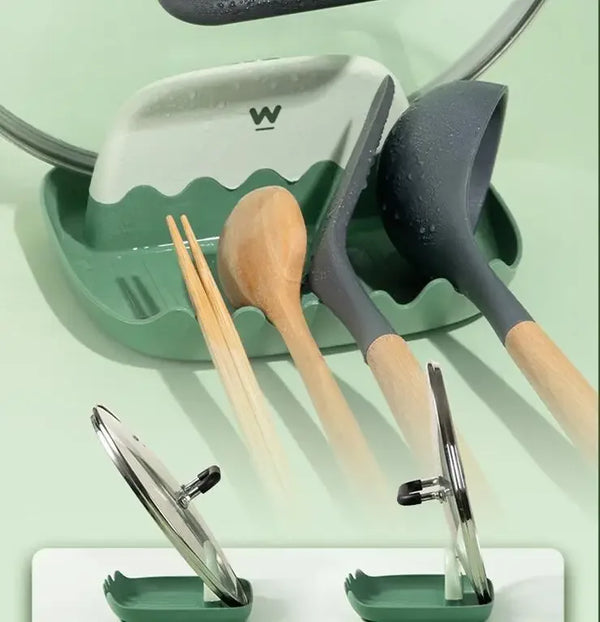 A set of kitchen utensils including spatulas and chopsticks are displayed in a green holder.