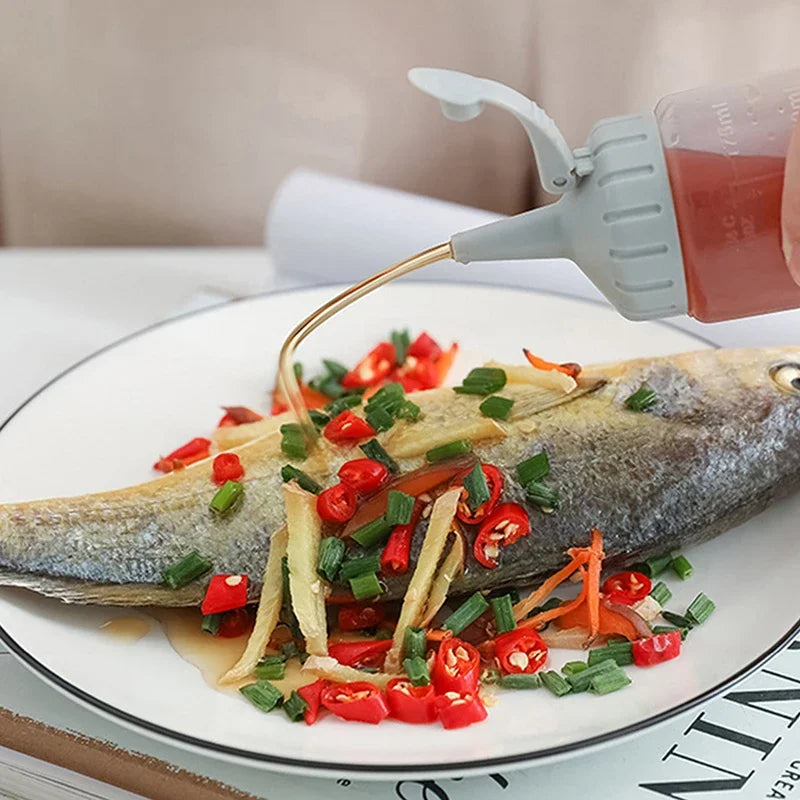 A fish fillet is being seasoned with oil from a squeeze seasoning dispenser bottle on a white plate.