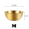 A brass-colored stainless steel mixing bowl with a measuring scale, shown from above.