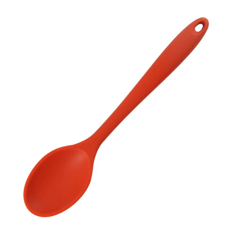 An orange silicone mixing spoon with a heat resistant coating.