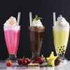 Three colorful iced beverages in glasses with reusable plastic straws and fresh fruit garnishes