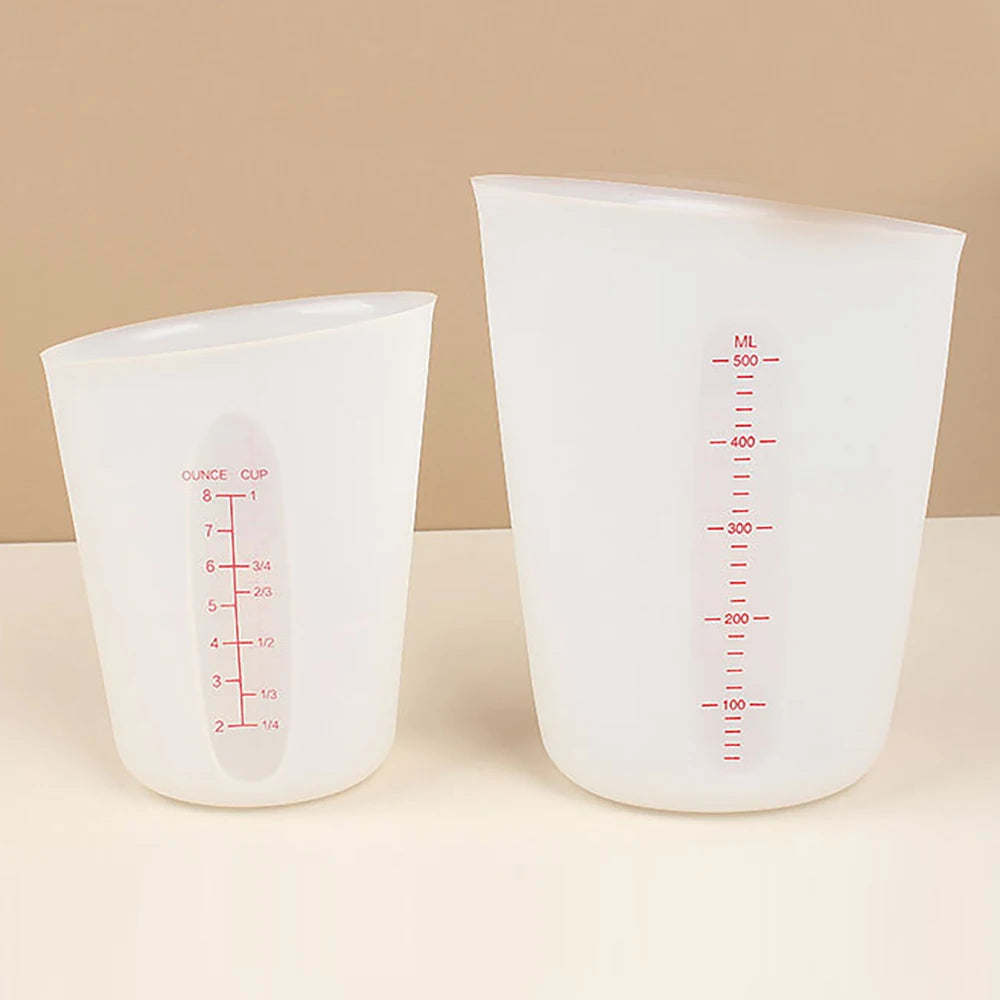 A clear silicone measuring cup with volume markings and a digital scale is shown on a light surface.