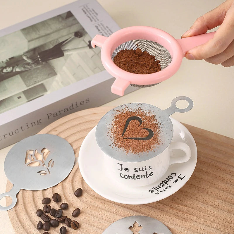 A hand holds a pink silicone baking stencil over a cup of coffee featuring the text Je suis contente.