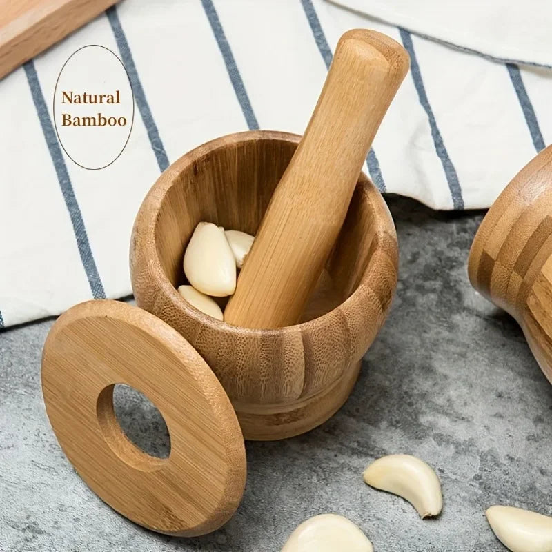 A wooden bamboo mortar and pestle set with several light-colored seeds or herbs on a gray surface.