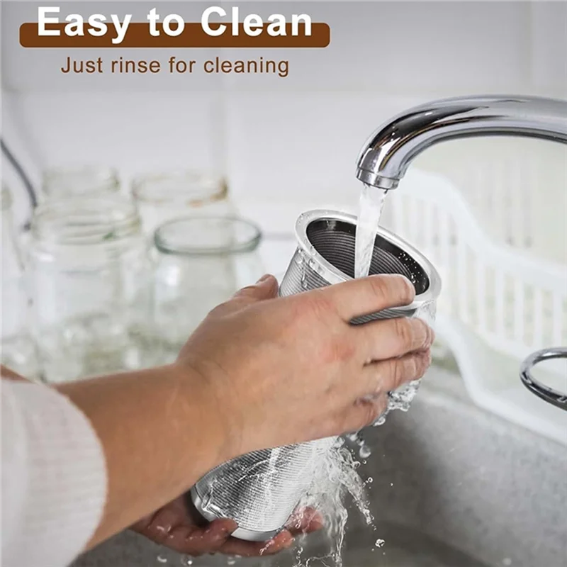 A hand is rinsing a 304 stainless steel cold brew filter for mason jars under running water.