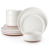 A stack of white and brown stoneware dinner plates and bowls.