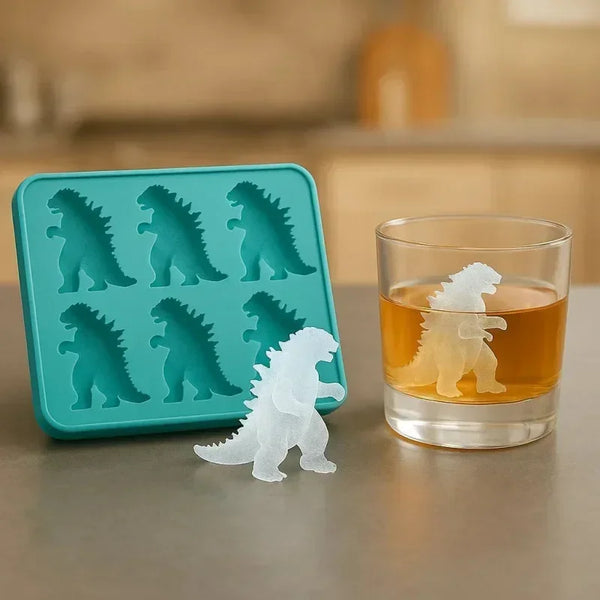 A teal silicone dinosaur ice cube tray set with several molded dinosaur shapes and a white dinosaur figure next to a glass.