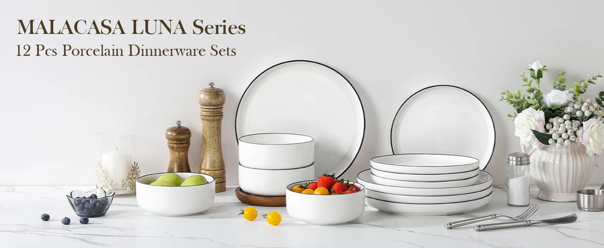 A collection of white porcelain dinnerware sets, including plates, bowls, and cutlery, displayed on a white marble surface.