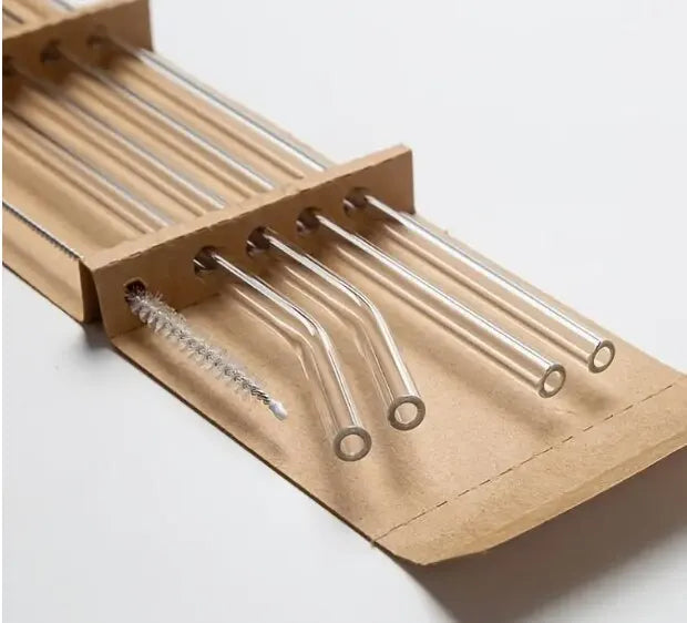 A brown cardboard holder containing a set of five clear glass straws.