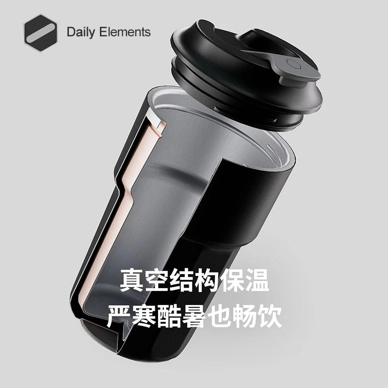 A black insulated stainless steel vacuum beverage cup with a lid shown in a studio setting.