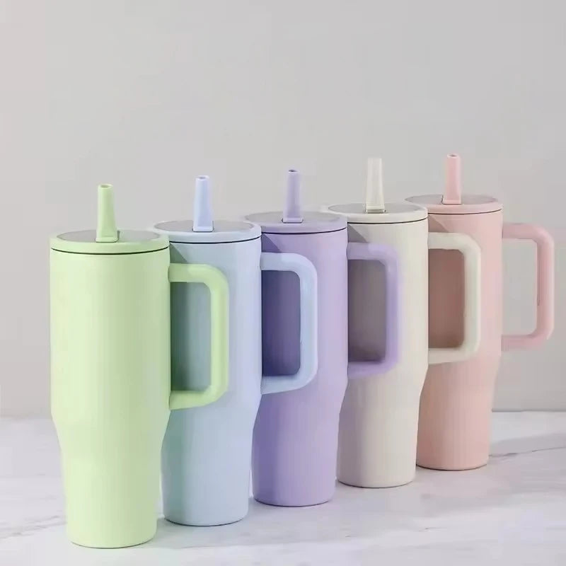 A set of five pastel colored insulated double-wall travel tumblers in shades of lime green, mint, lavender, and pink.