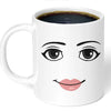 A white ceramic coffee mug featuring a stylized black line drawing of an expressive face with large eyes and pink lips.