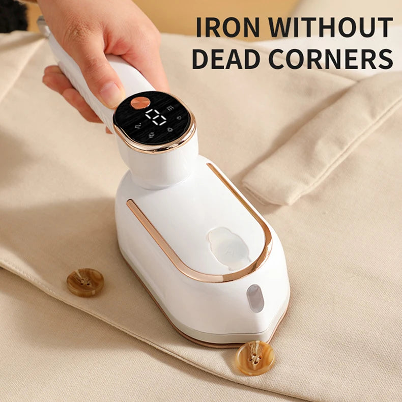 A white foldable handheld garment steamer is being held by a hand on a beige cloth.