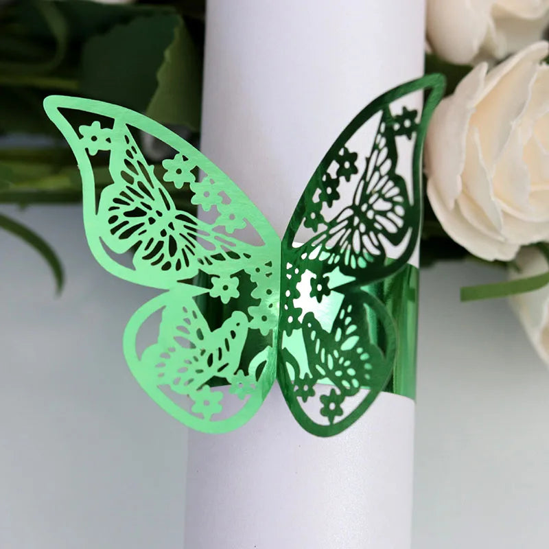 Green laser cut butterfly napkin rings displayed on a white cylindrical object.