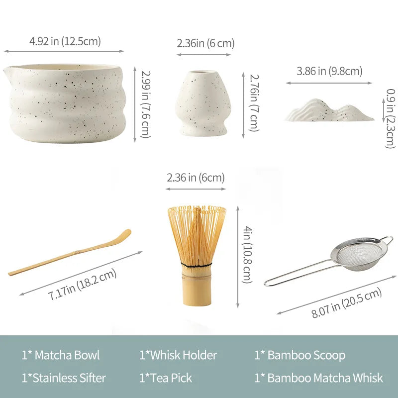 A set of traditional Japanese matcha tea tools including a bowl, whisk holder, bamboo scoop, and tea pick.
