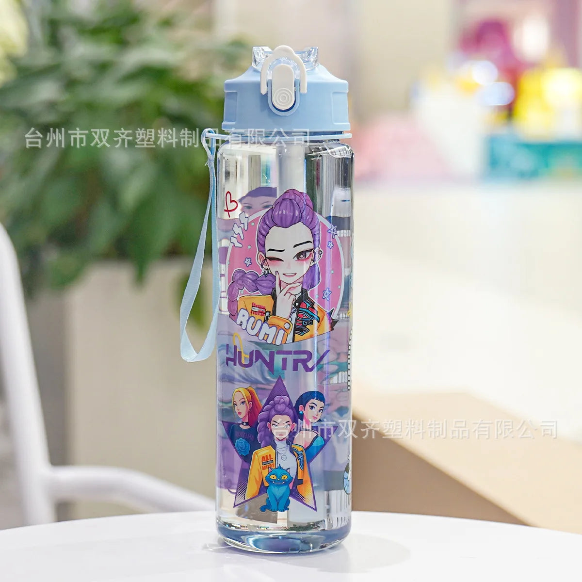 A clear insulated water bottle with a purple cartoon print featuring a female character and text on the body.