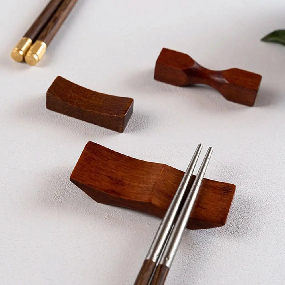 A set of wooden silicone utensil holders and a pair of chopsticks are displayed on a white surface.