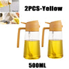 Two 500ml yellow dual-function kitchen oil spray bottles shown with oil inside.