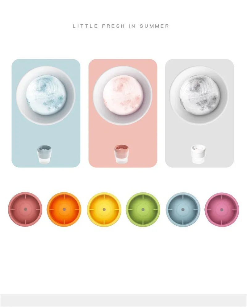 A set of colorful stackable food-grade ice molds for cocktails in various shades of pink, orange, green, and blue.