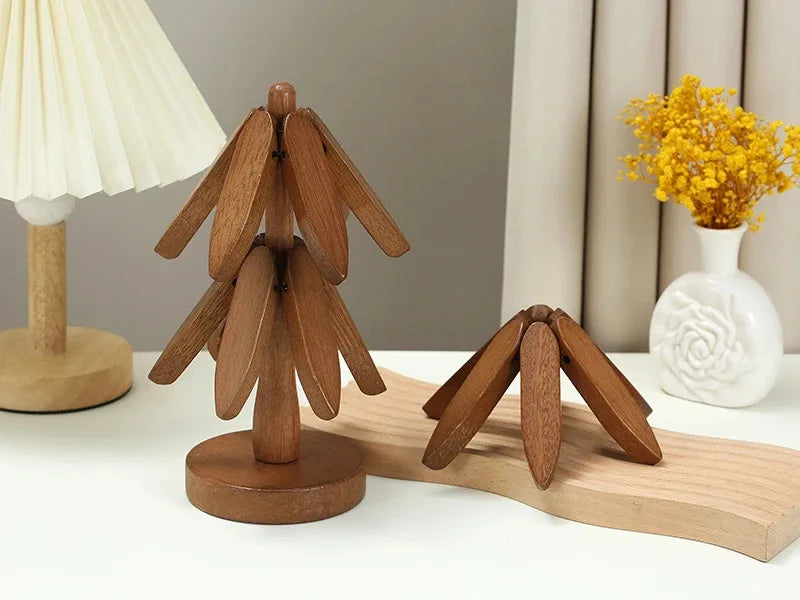 A set of natural wood insulation coasters displayed on a light wooden board with a yellow flower in the background.