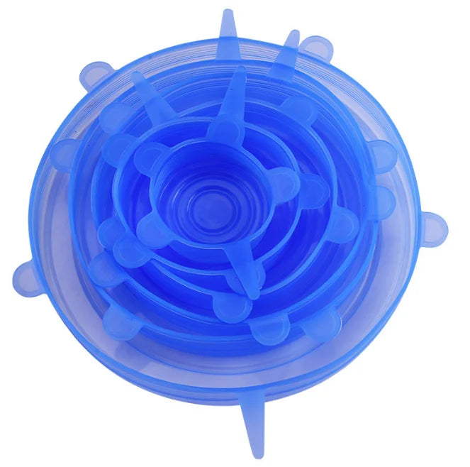 A clear silicone food lid set with multiple circular indentations and a small protrusion.